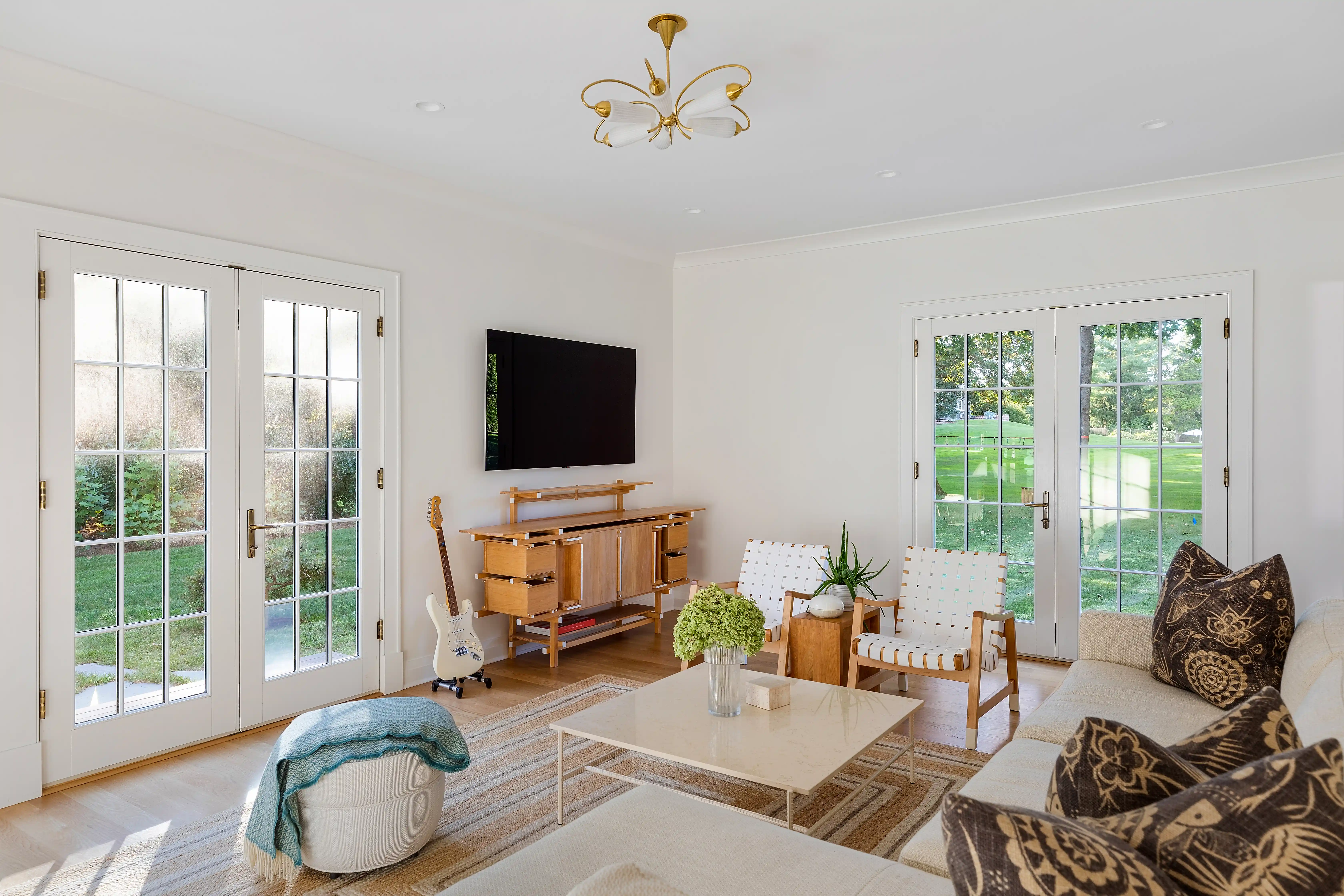 Custom home family room with natural lighting and modern furniture