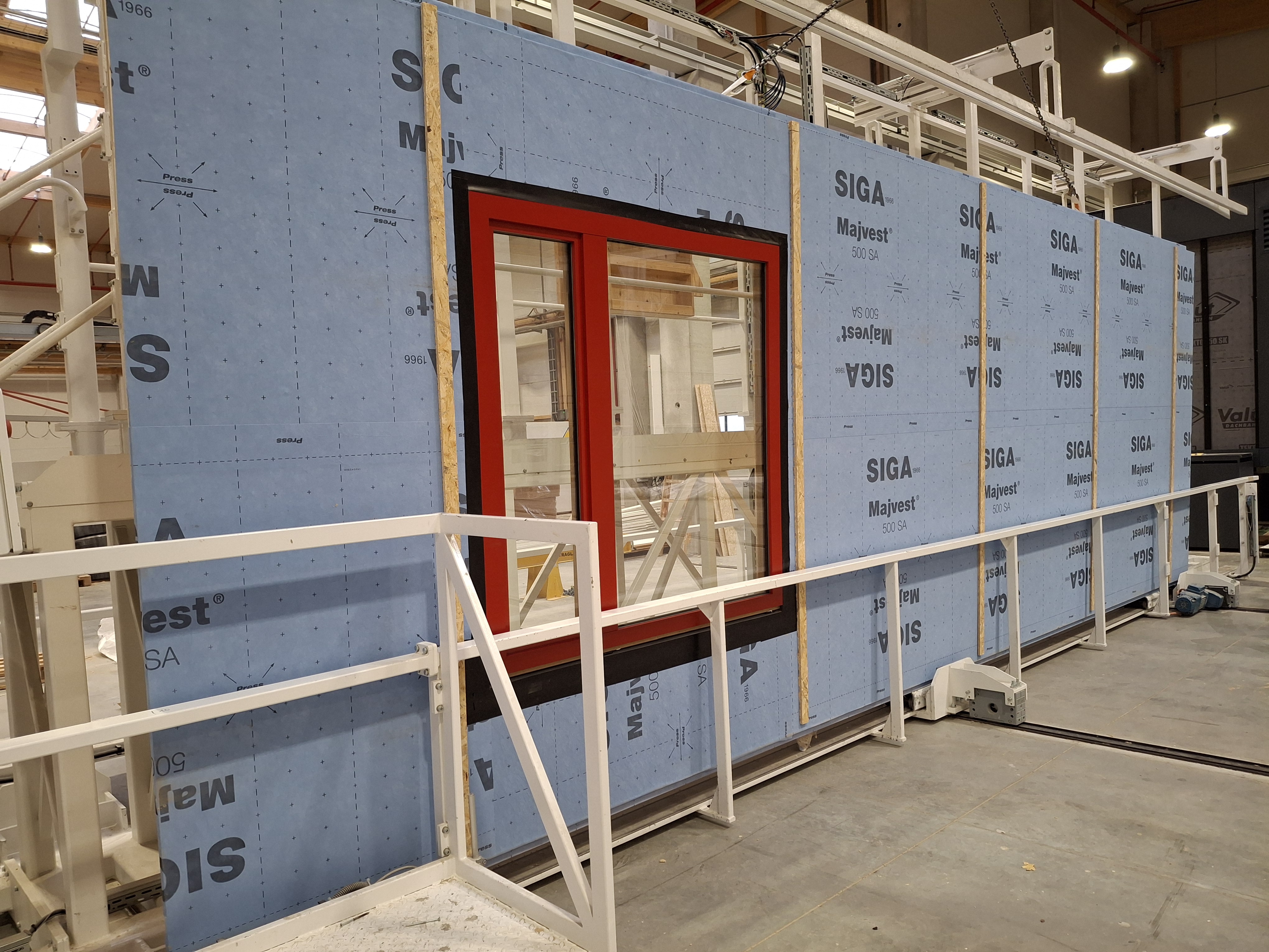 Factory-built modular wall assembly featuring a custom window installation
