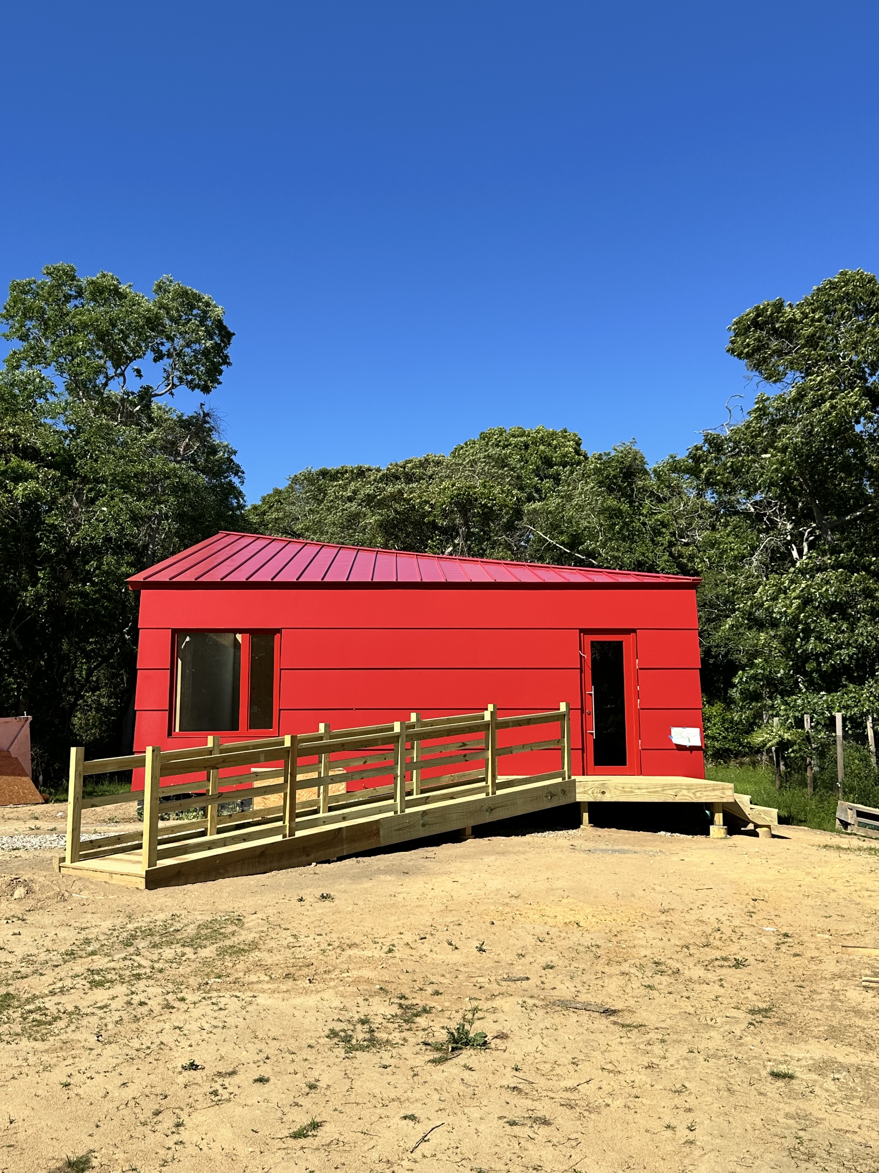 MH modular home featuring a modern red exterior