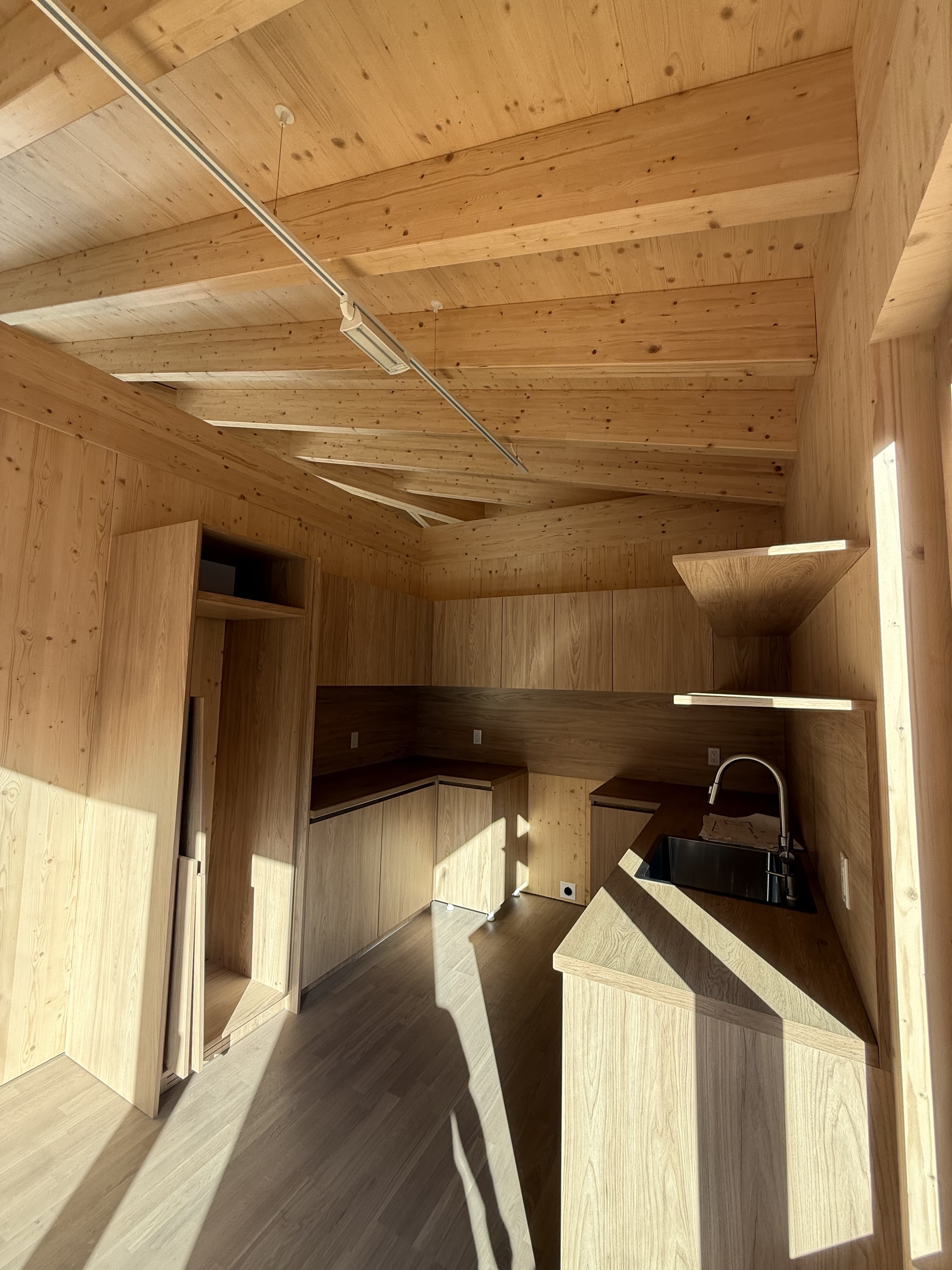 Modern modular home kitchen featuring natural wood finishes