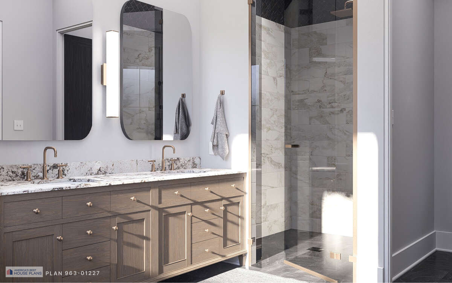 Luxury primary bathroom with double vanity, marble countertops, and glass walk-in shower