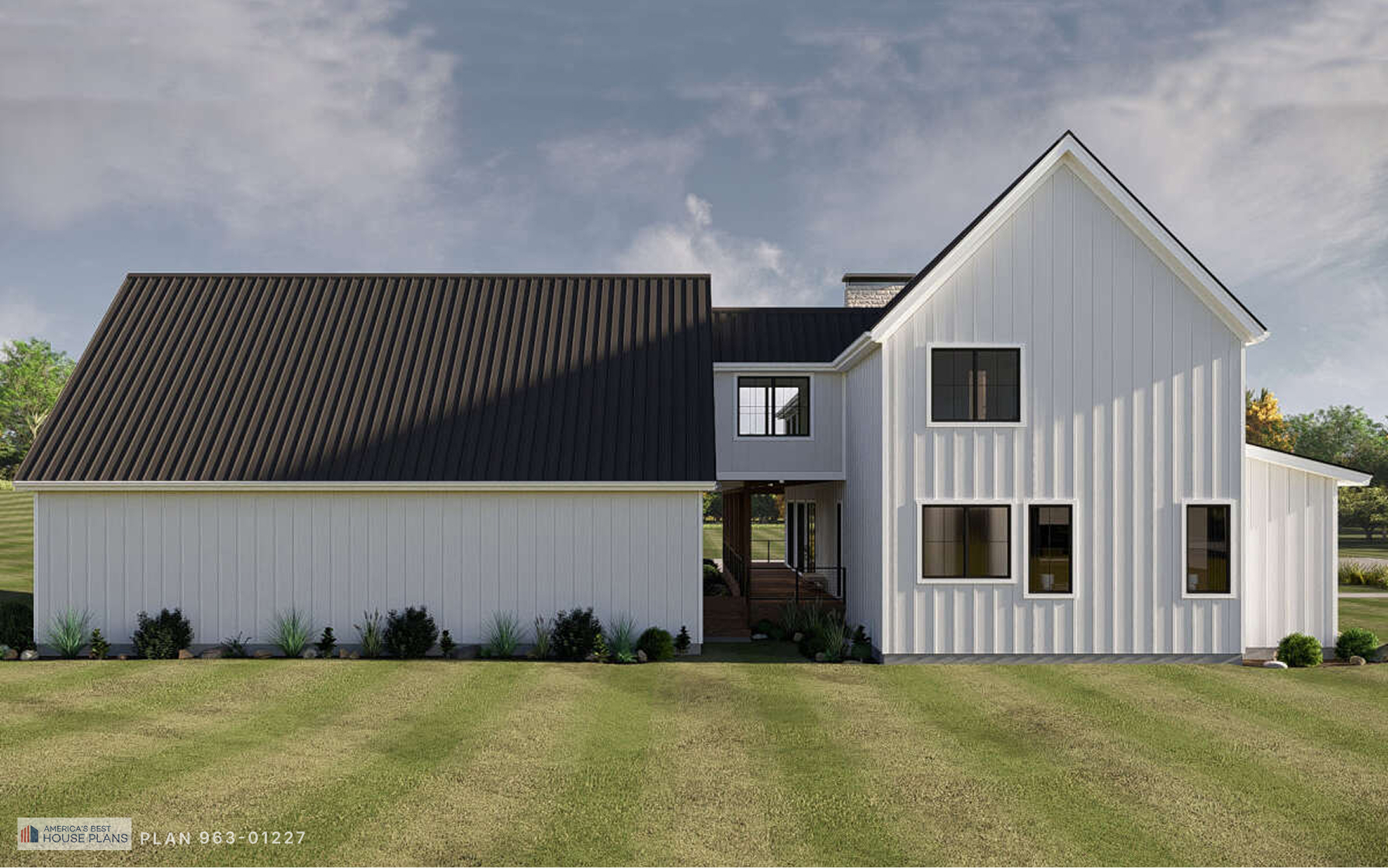 Rear side elevation of a modern Barndominium with white board and batten siding and black metal roof