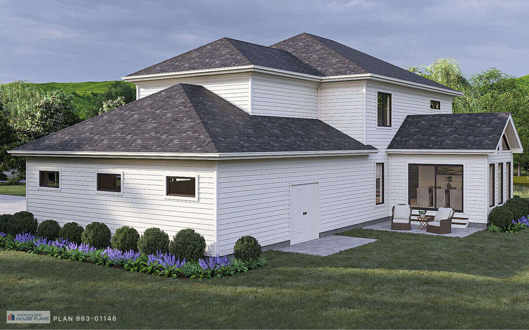Rear corner view of a Cape Cod home with attached garage, backyard patio, and landscaped yard