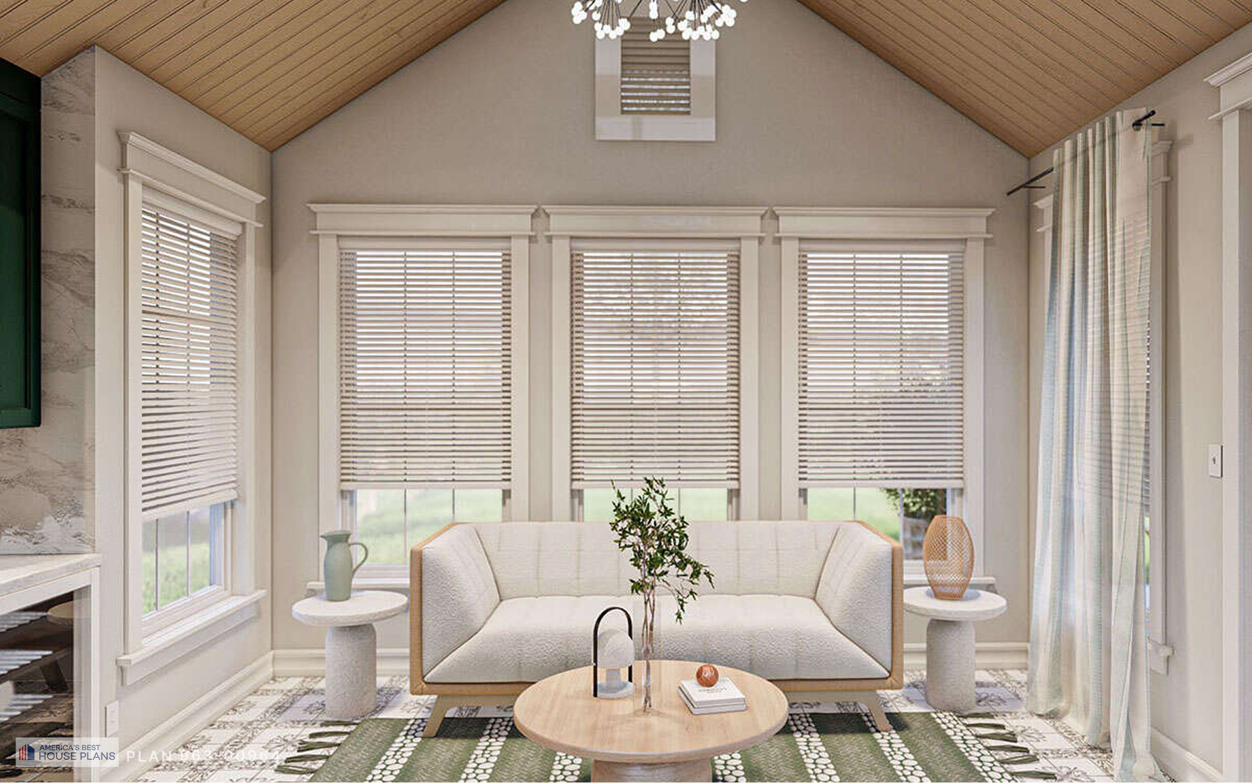 Cozy cottage living room with vaulted wood ceiling, large picture windows, neutral sofa and round coffee table