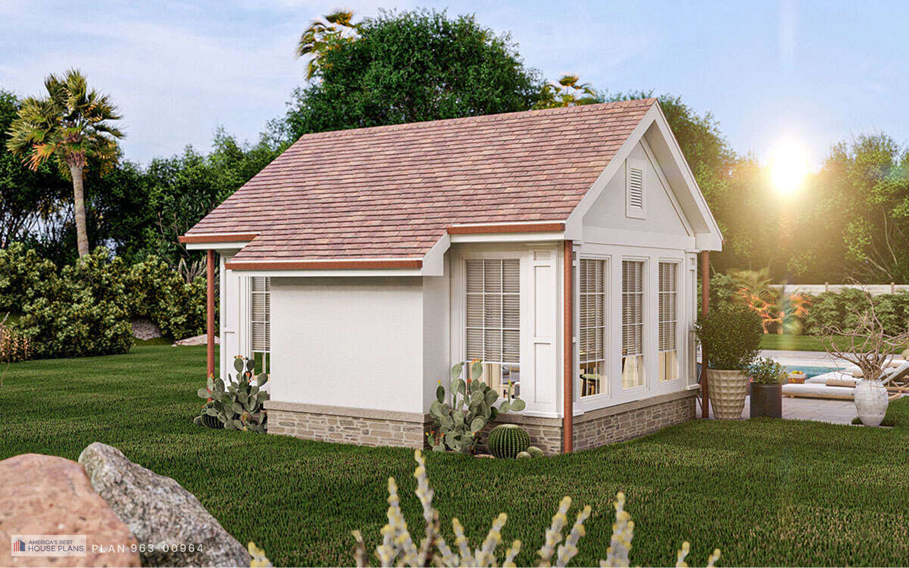Cottage guest house featuring white siding, large windows, stone base, and landscaped garden beside the pool