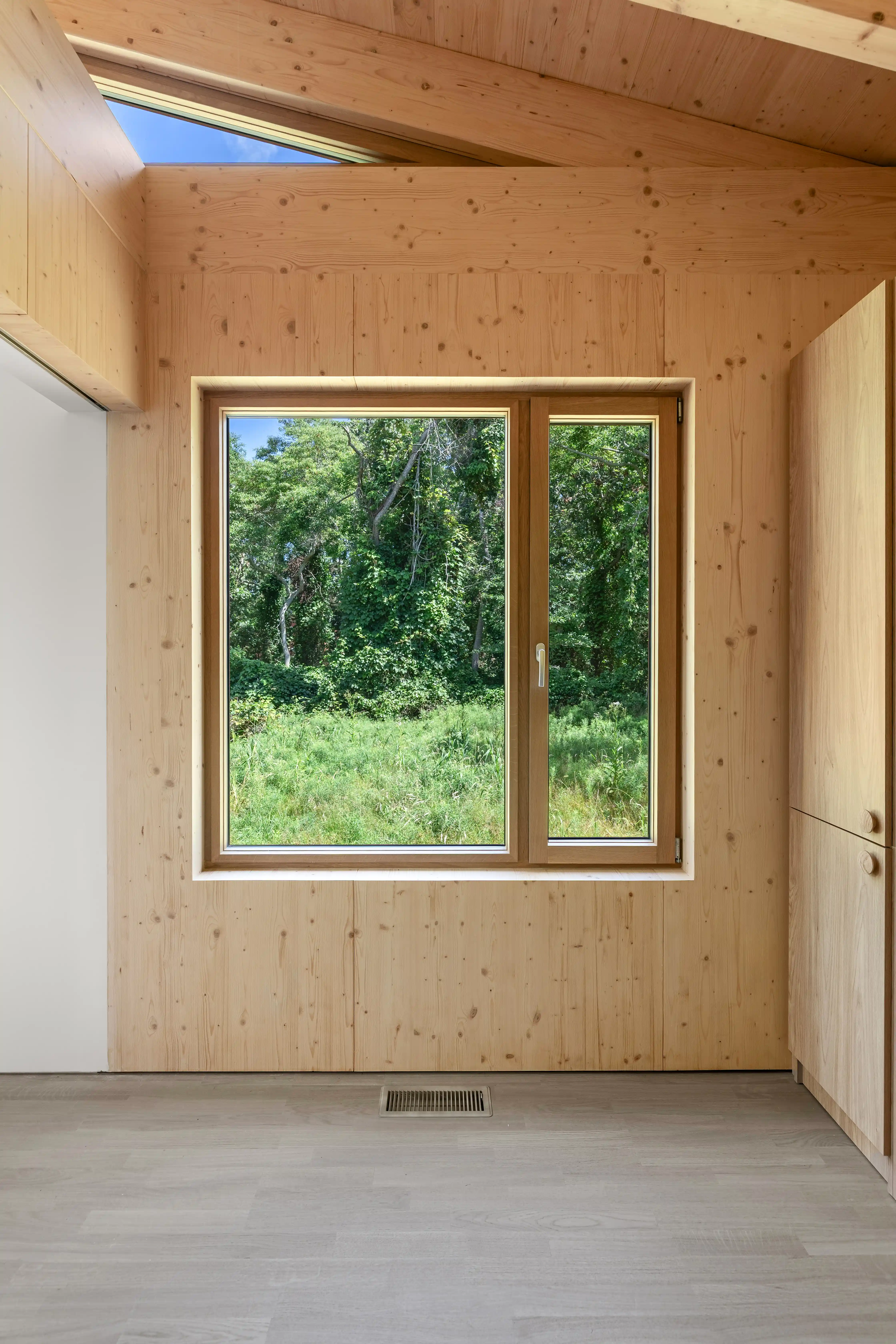 Ma’s House timber interior with landscape window