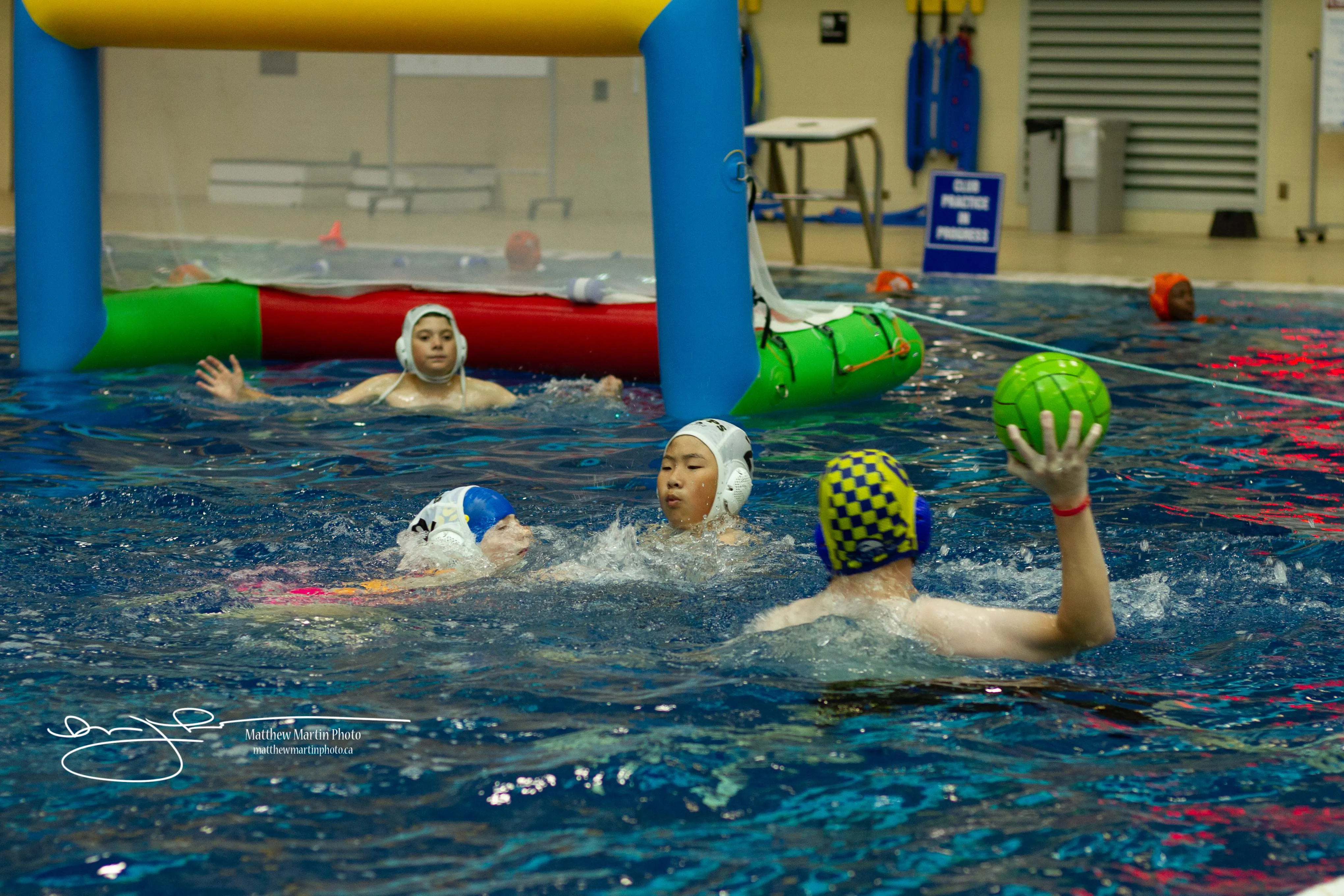 Young players in a Minipolo game in shallow water with inflatable goals