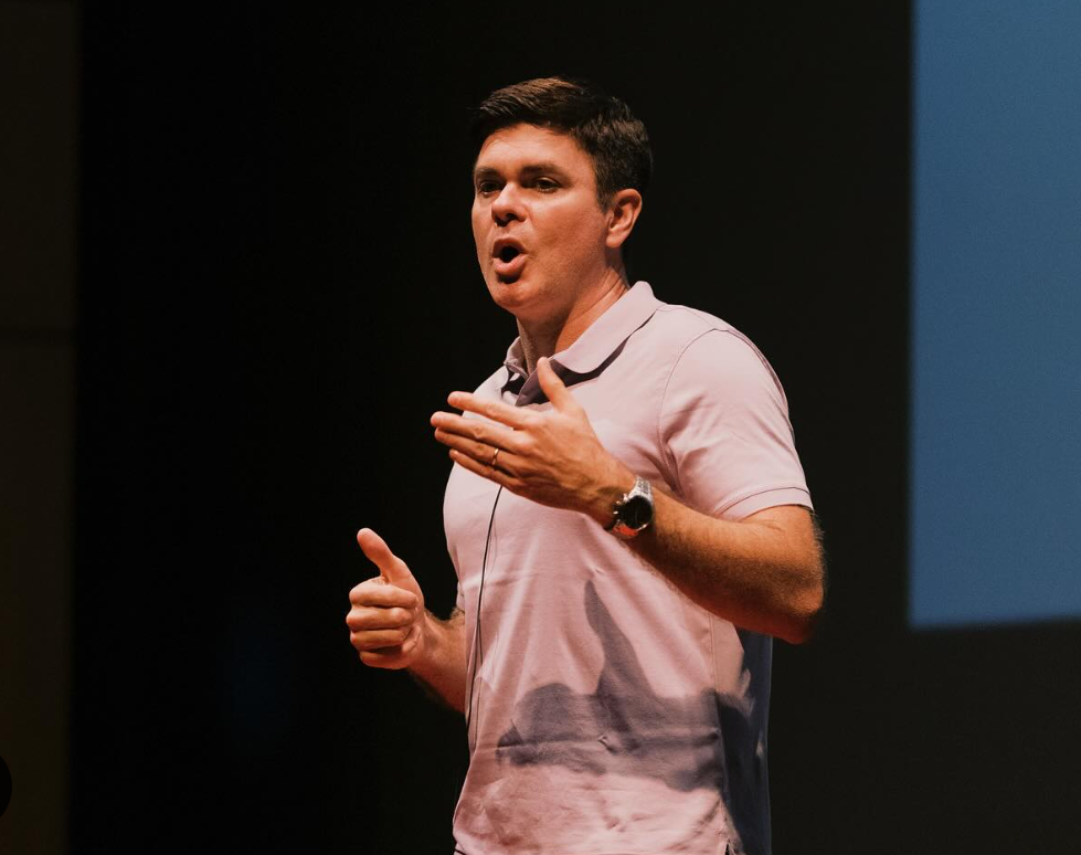 Christopher D. Connors speaking on stage at his first TedX event.