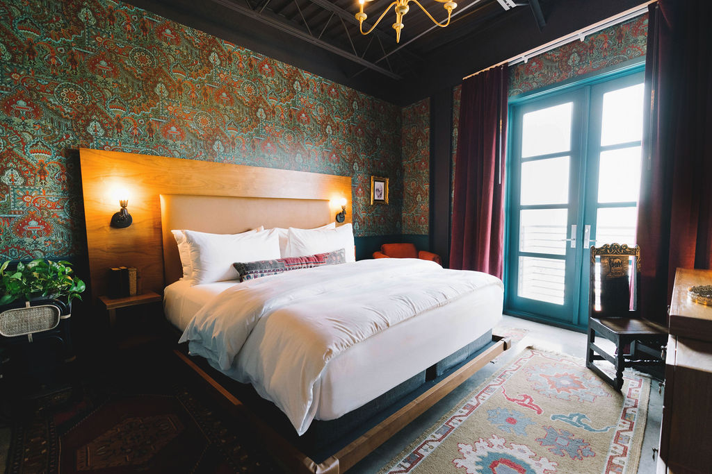 Hotel room with a luxurious King bed and Juliet balcony at the Frances Modern Inn in Austin.