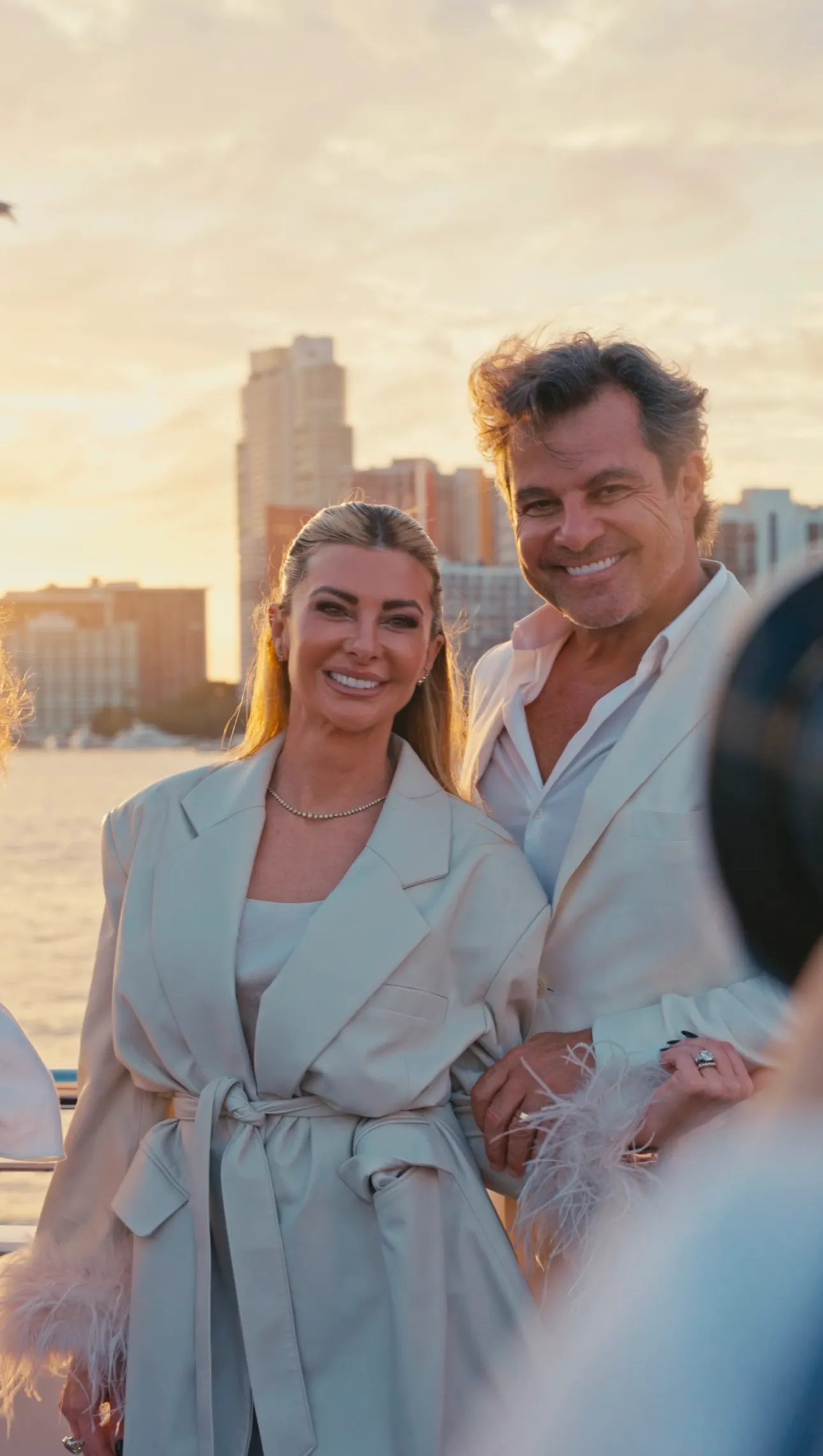 Couple dressed in white on a Miami waterfront for a brand video