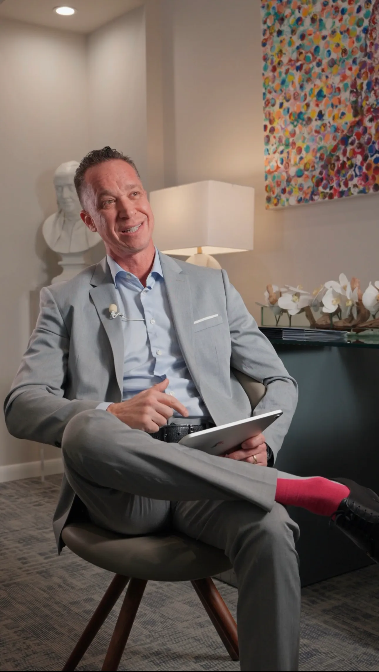 Executive in a grey suit seated for a cinematic interview