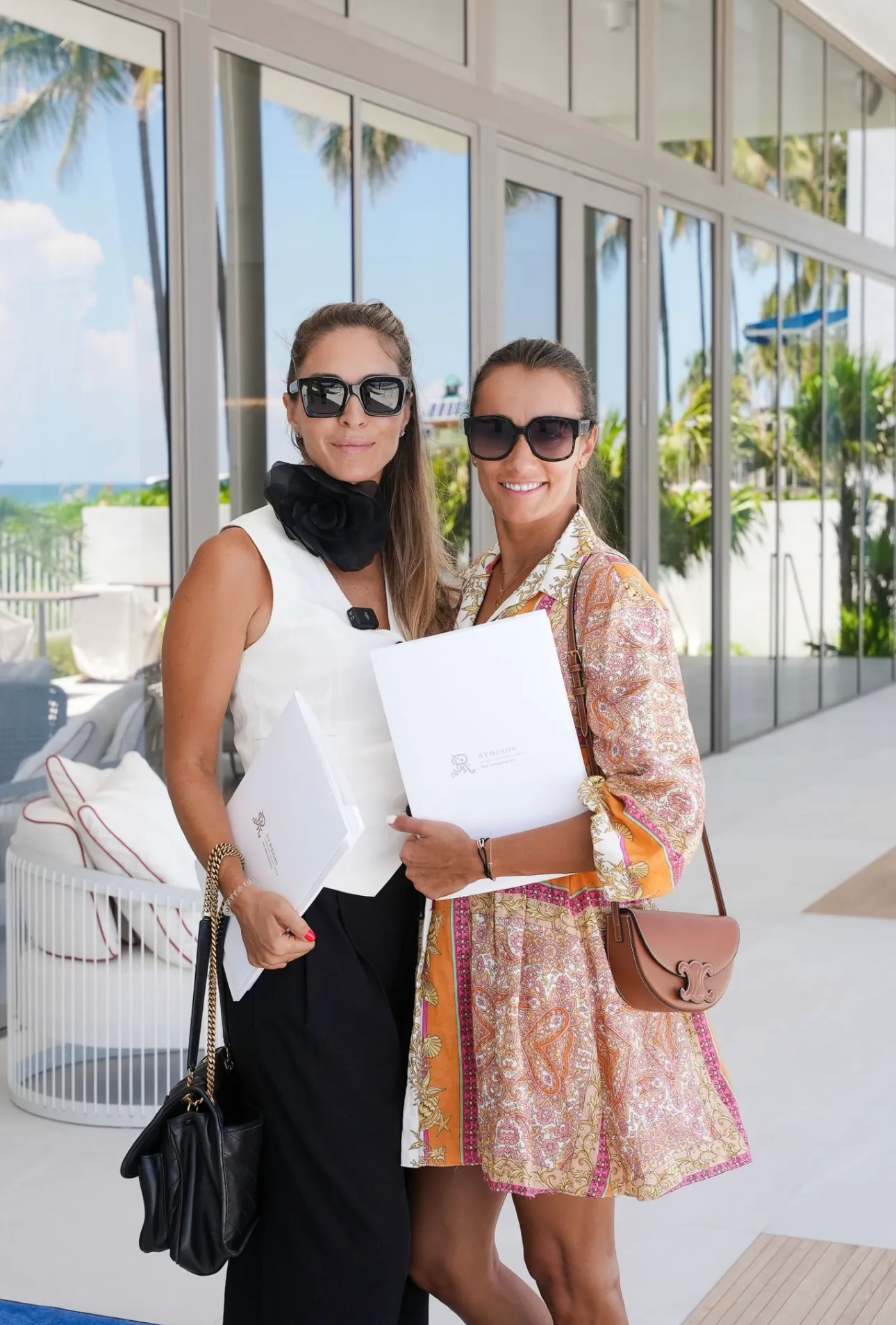 Two real estate professionals at a waterfront sales gallery