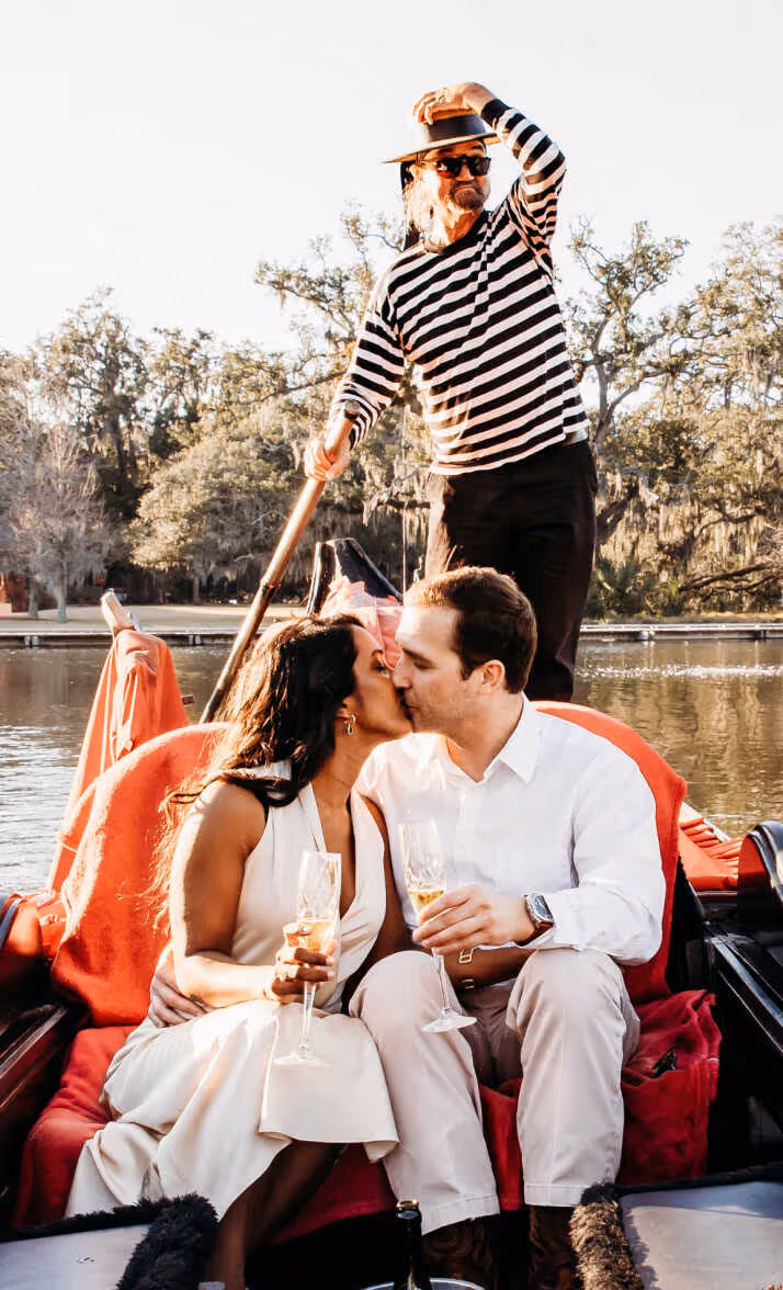 A man and woman kissing on a boat.