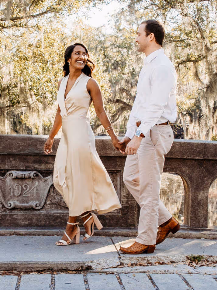 A man and woman walking arm in arm.