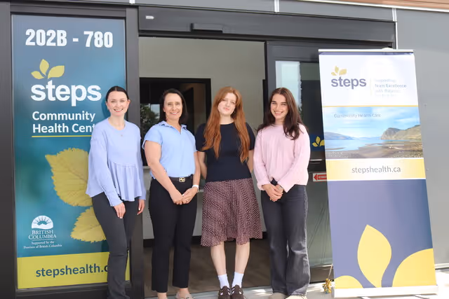 Three happy staff members standing together
