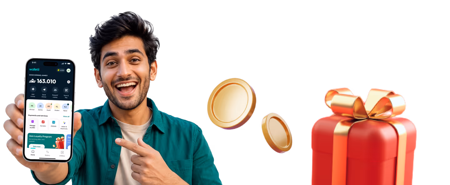 Smiling man in green shirt pointing to a phone screen showing wallet app with coins and gift box nearby.