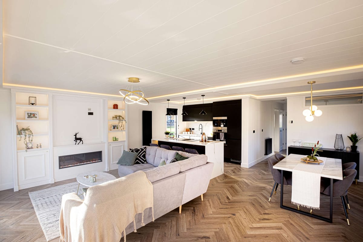 Contemporary Open-Plan Living Room and Kitchen with Modern Decor, Elegant Lighting, and Light Wood Flooring