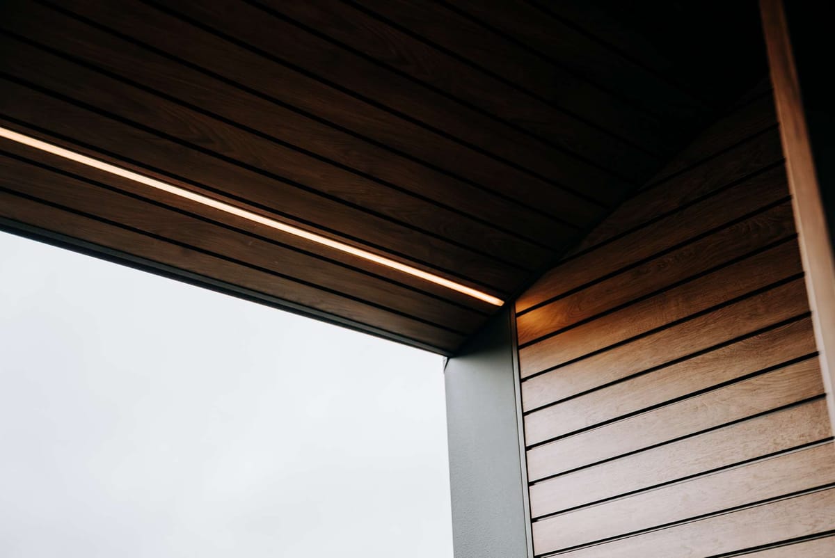 Modern Architectural Design with Wooden Panel Ceiling and Ambient Lighting in Angular Perspective