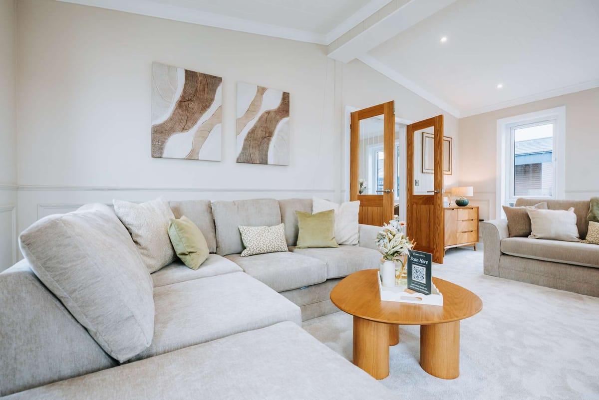 Contemporary Living Room with Neutral Tones Featuring L-Shaped Sofa, Abstract Wall Art, and Wooden Accents
