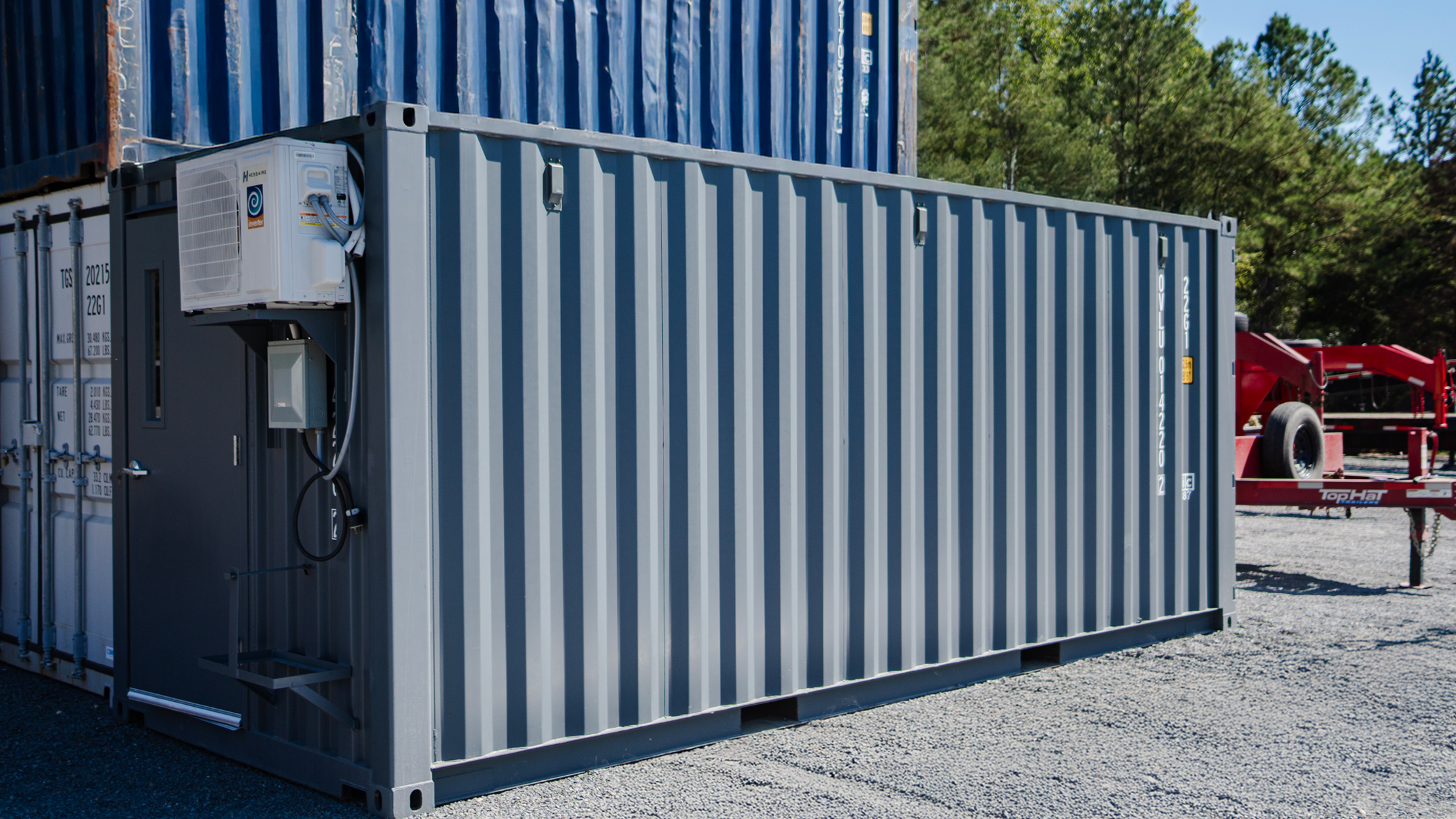 Custom cool-down container with industrial gray finish, exterior mini-split HVAC system, and electrical hookup—engineered for jobsite cooling, break areas, or climate-controlled workspace.