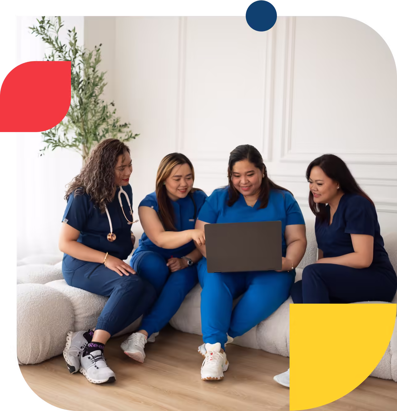 Nurses huddling in front of a laptop