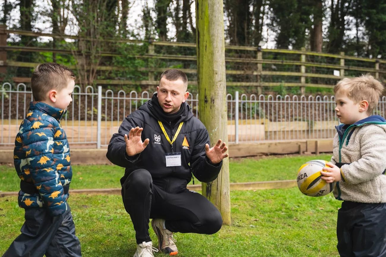 A Delta Coach explaining a Rugby exercise in a PE Lesson. 