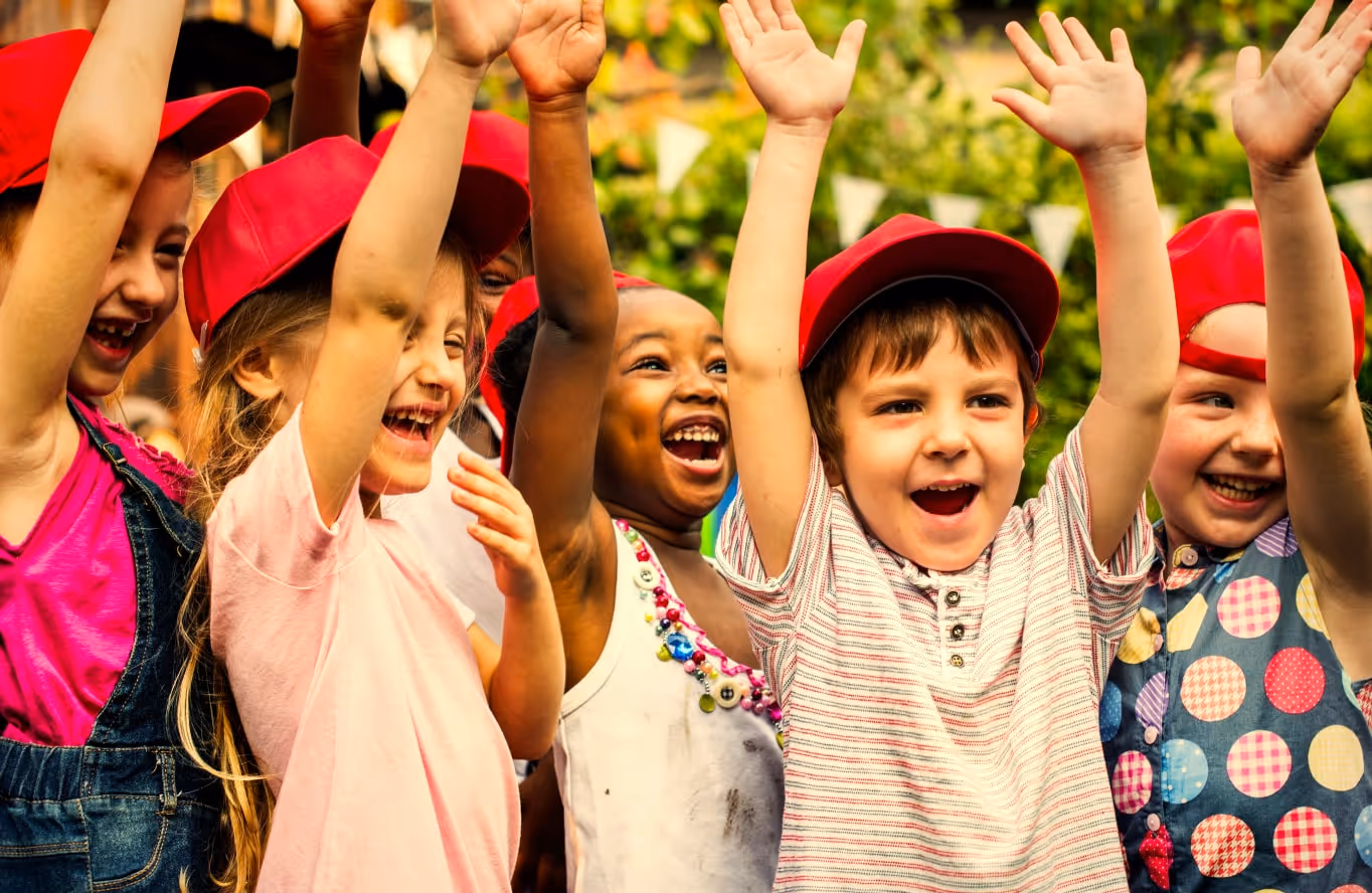 Kids cheering in excitement at their summer camp