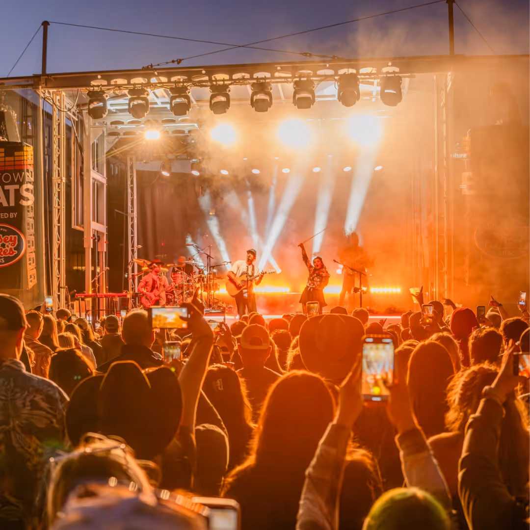 Man on stage performing in front of crowd