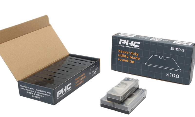 Box and plastic cases of PHC heavy-duty utility blades with round tip, each box containing 100 blades.