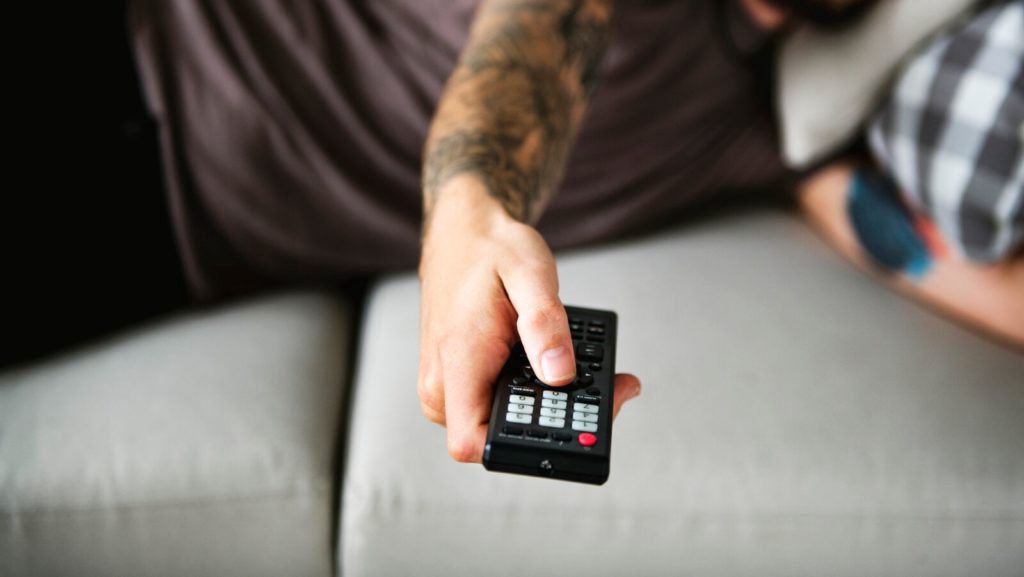 man holding remote control