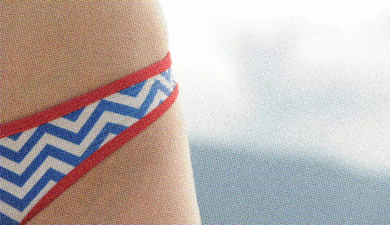 A close-up of a person's hip and the front of their torso. They are wearing patterned underwear.