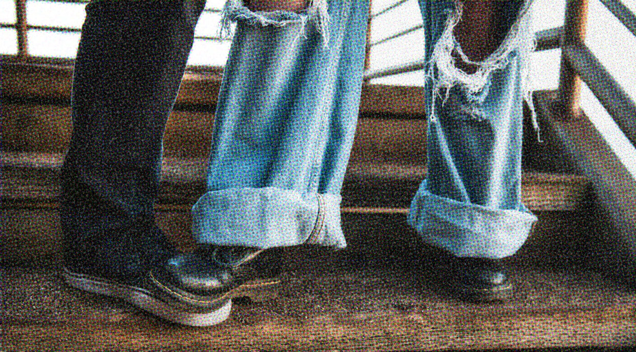 Two people wearing casual clothing, pictured from the knees down.