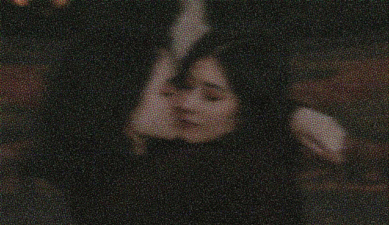 Two people embrace. The image quality is dreamily fuzzy, like a hug.