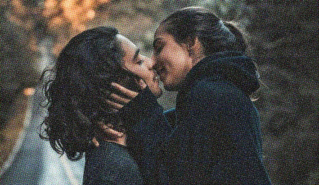A couple kiss passionately. They're in the moment, enjoying their connection, concentrating on their experience.