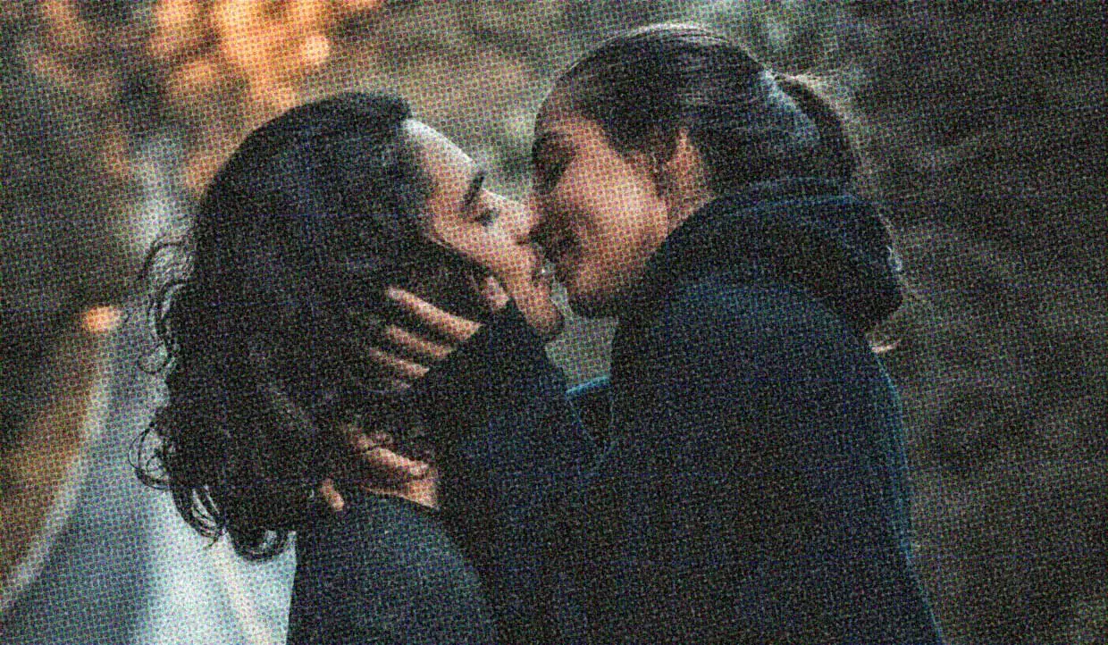 A couple kiss passionately. They're in the moment, enjoying their connection, concentrating on their experience.