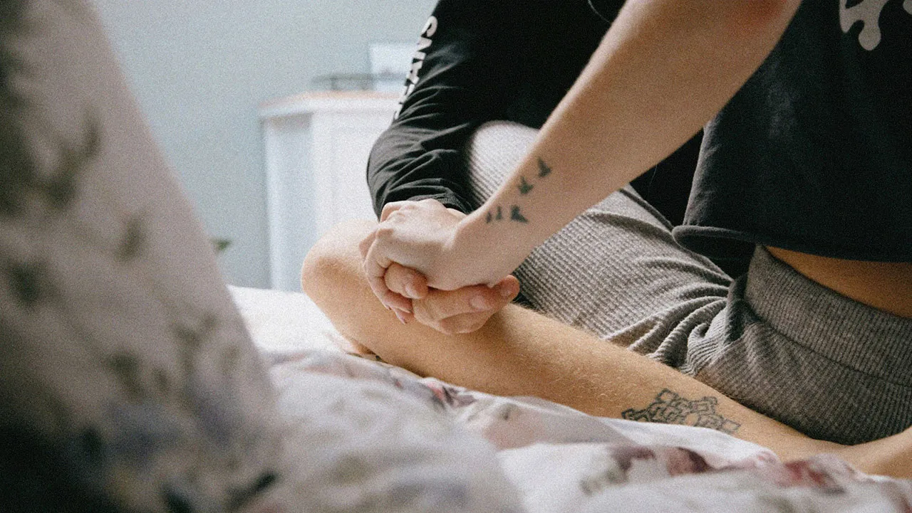 HUD App - couple sitting crosslegged on bed - what is outercourse