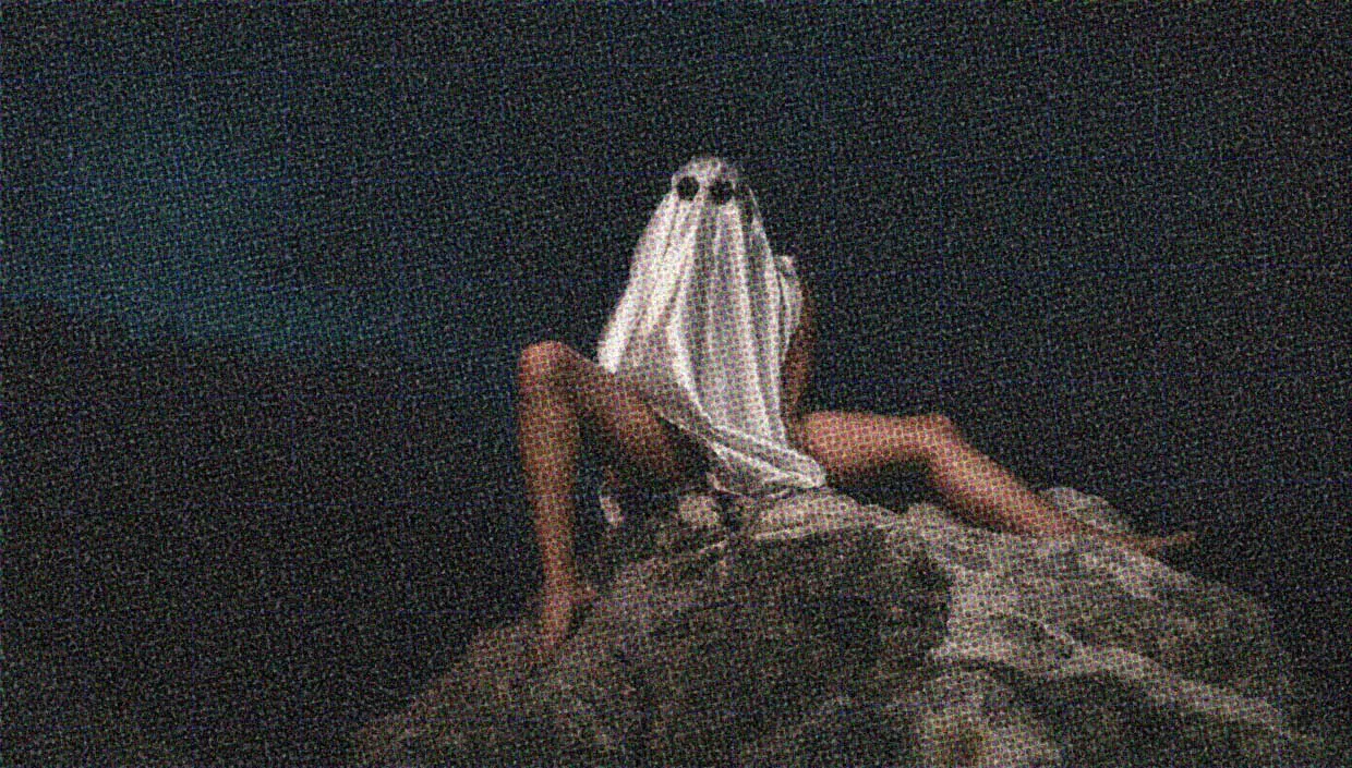 A ghost with sexy bare legs perches on a rocky outcrop. Okay, it might be a half-naked guy wearing a sheet.