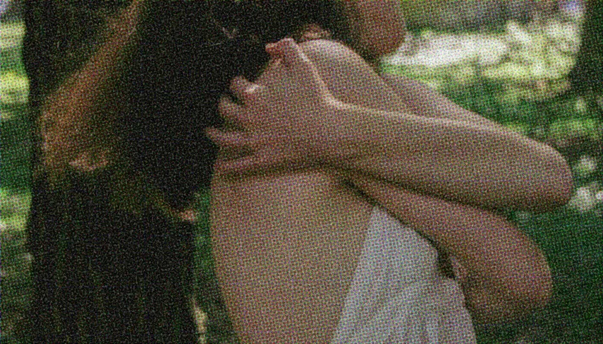 A woman hugs herself.