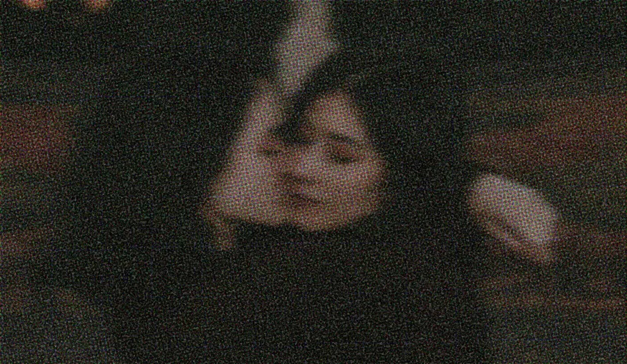 Two people embrace. The image quality is dreamily fuzzy, like a hug.