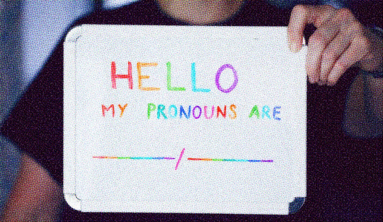 HUD App - Person holding whiteboard - Pronouns why they matter and how to use them