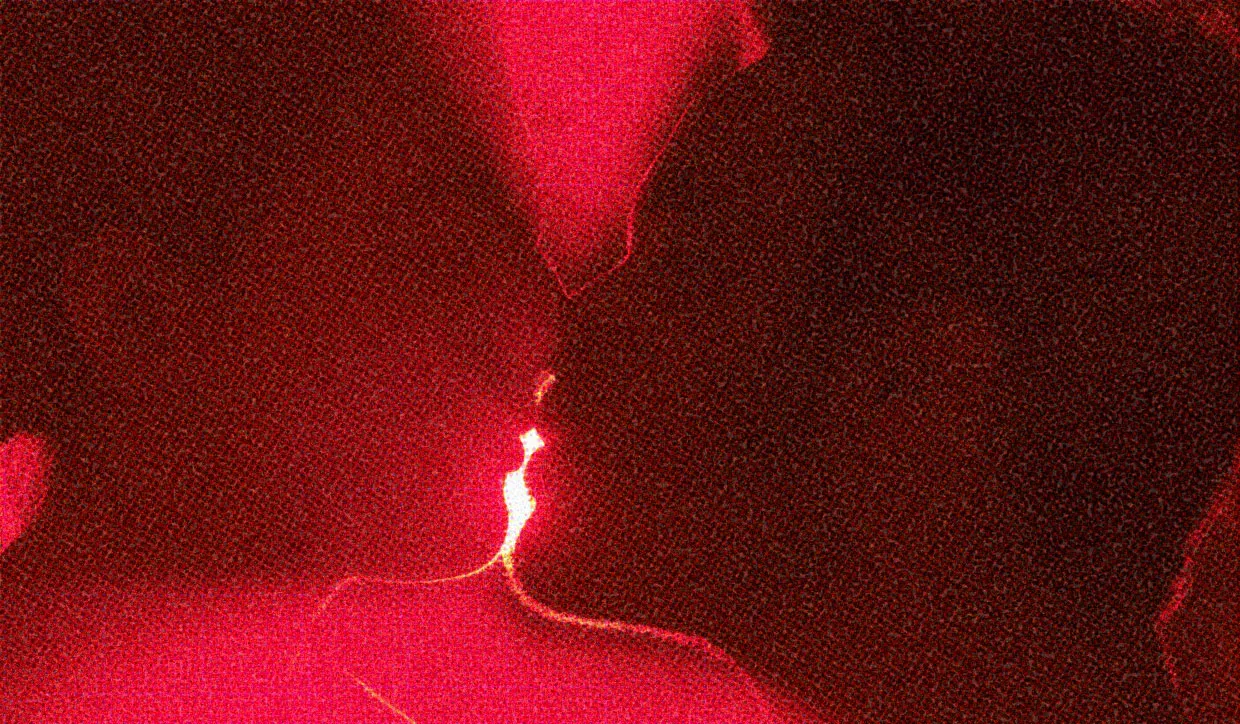 HUD App - Close up of people kissing in front of red light - Reasons kissing is good for you