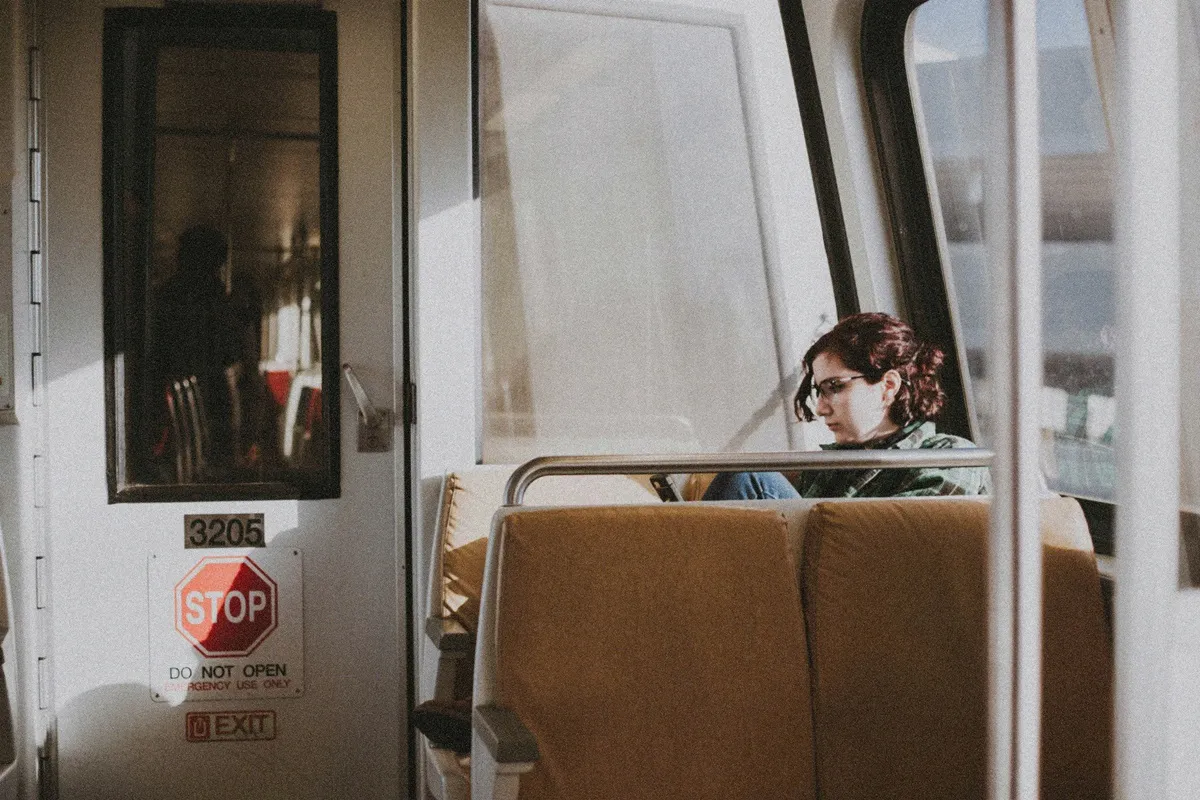 HUD App - Person reading on train - Why your morning commute is perfect for dating