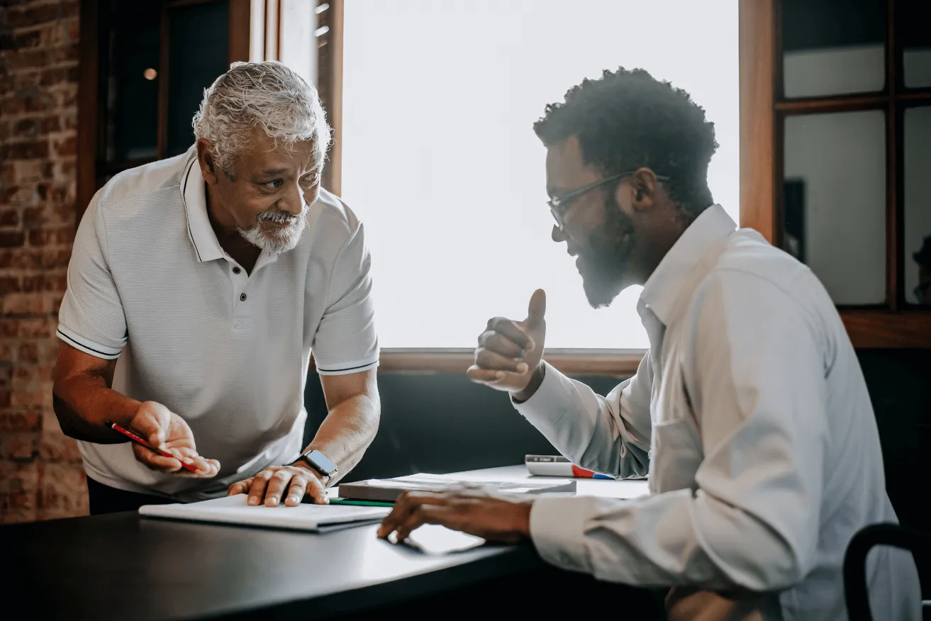 A couple of men sitting at a table.