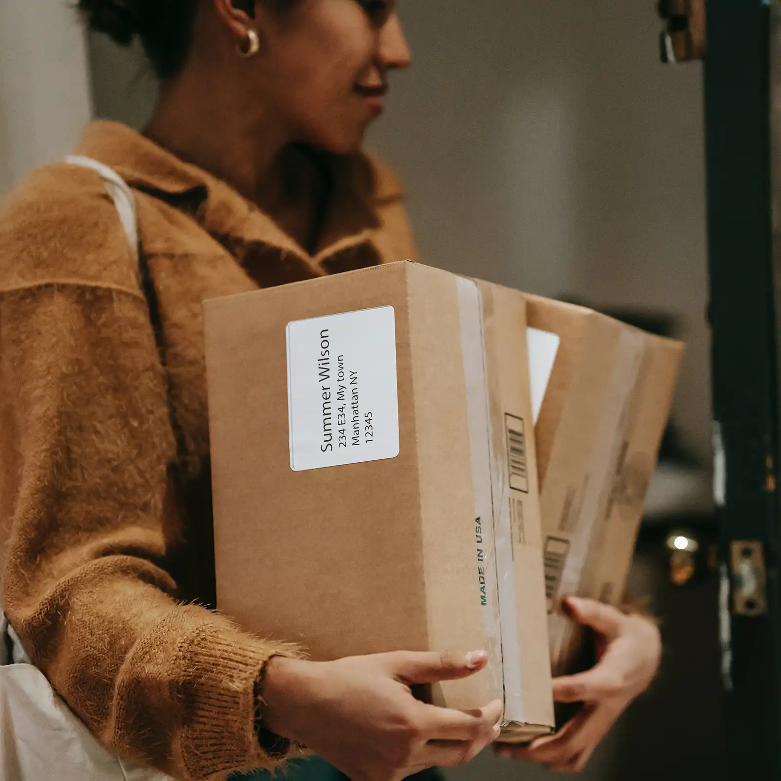 Woman carrying shipping packages