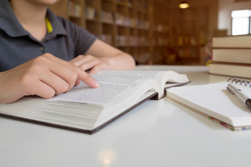 Student studying VCE English Language exam past papers at a desk during SWOTVAC revision