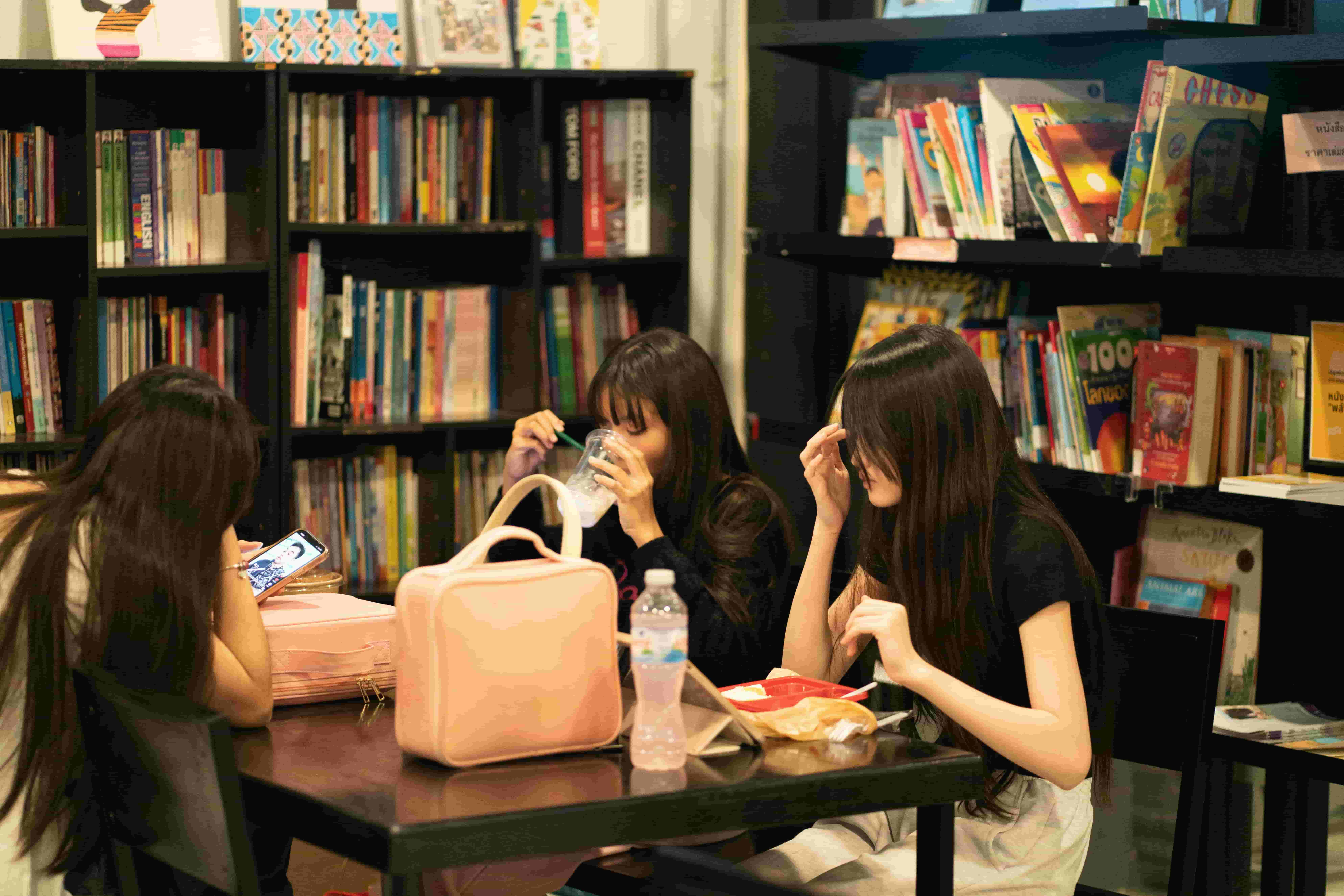 Students taking a study break together while preparing for VCE English Language in a library