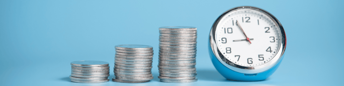 3 piles of a coins next to a stopwatch to signal stock market timing and entry points.