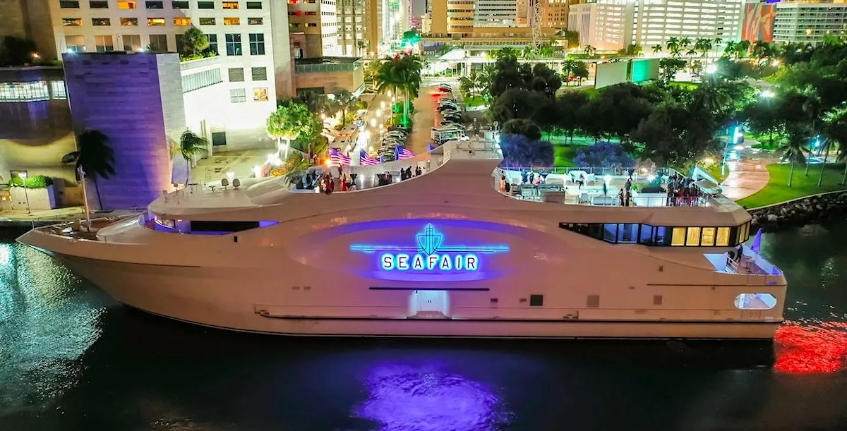 The Seafair Grand Luxe lit up at night at the dock in downtown Miami