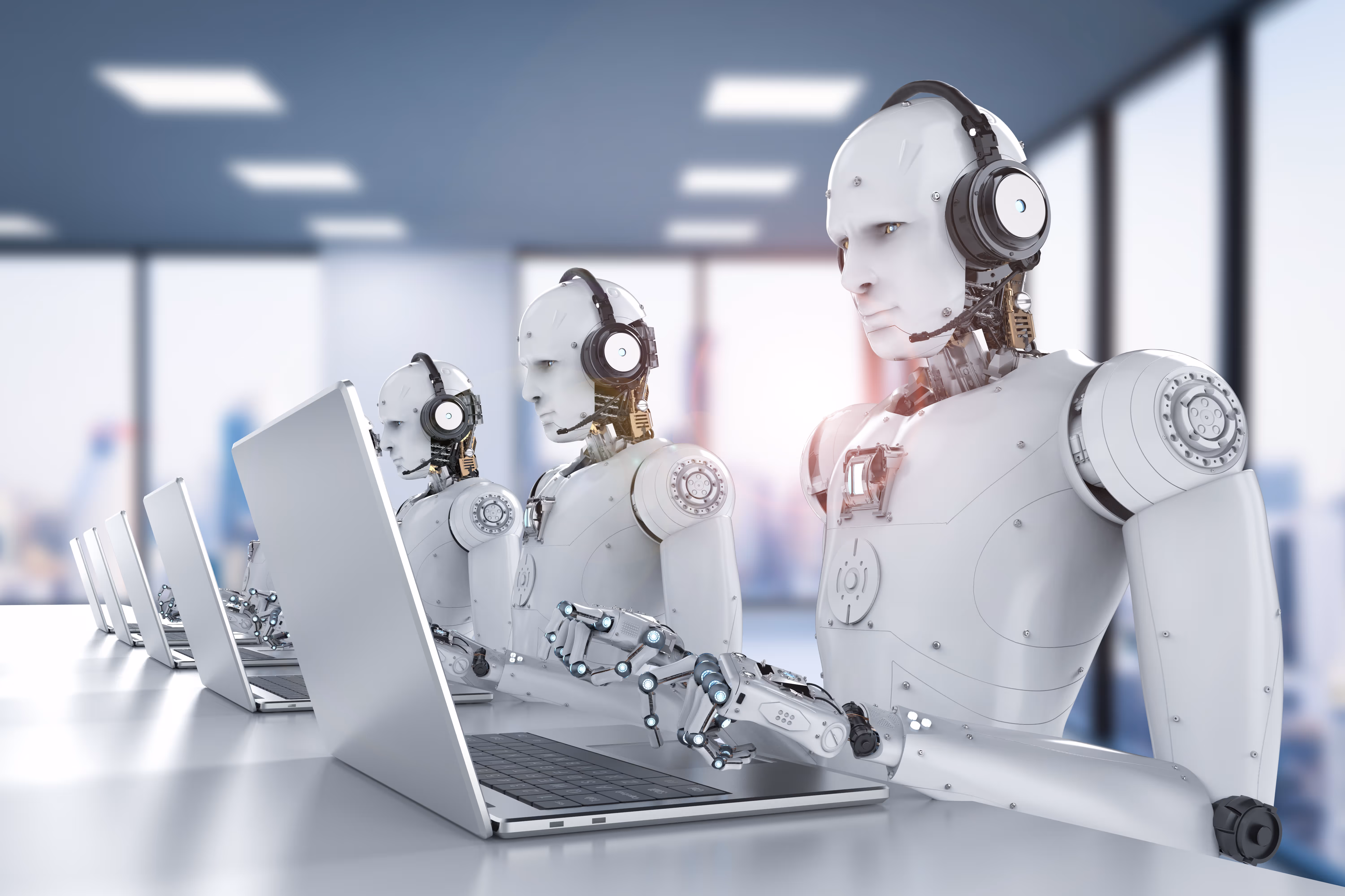 Row of humanoid robots wearing headsets and working on laptops in a modern office