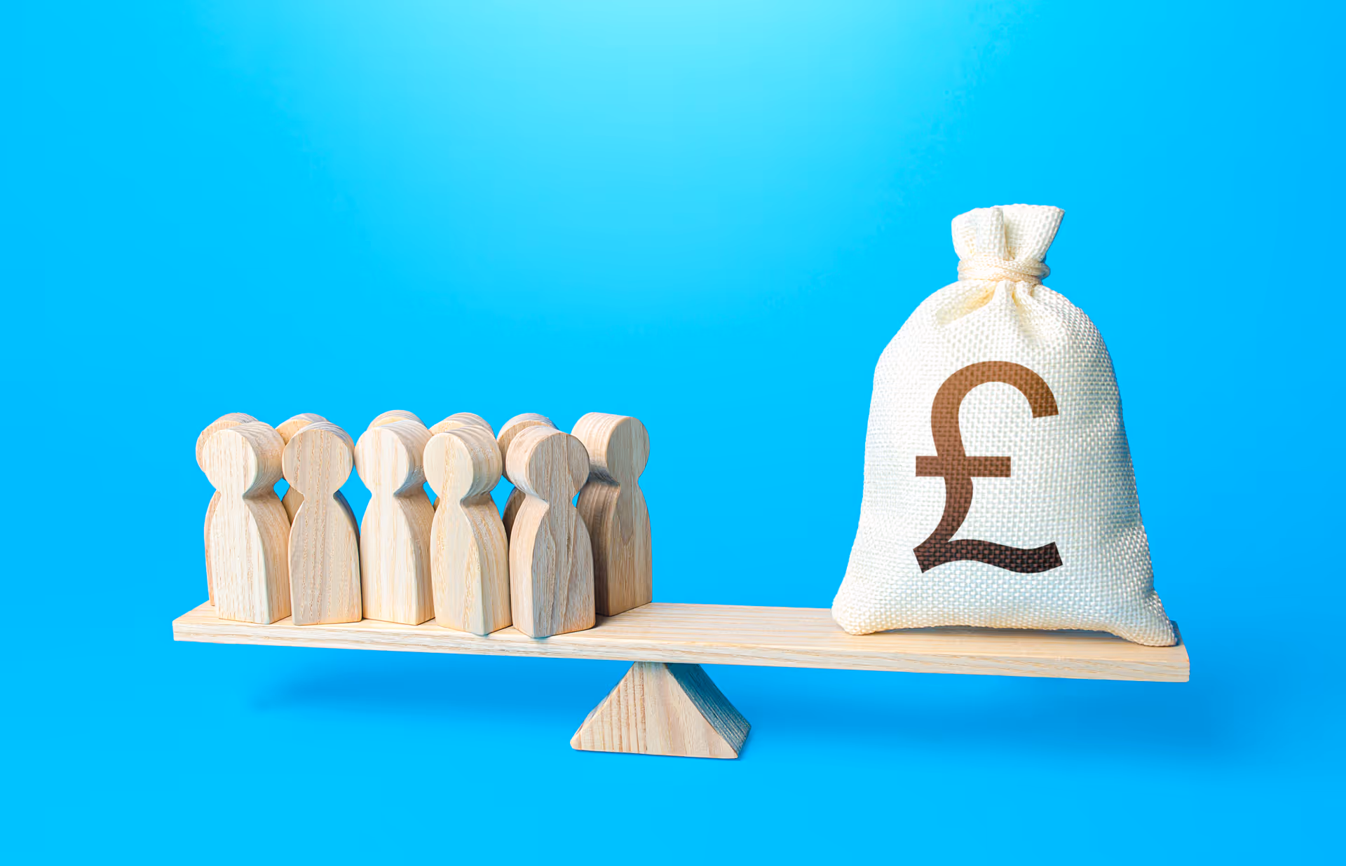 Wooden figures on one side of a balance scale and a money bag on the other, showing inequality in pay or workforce value